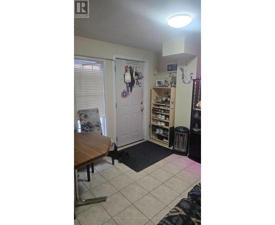 A room with a table and a door with a decorative plate on it.