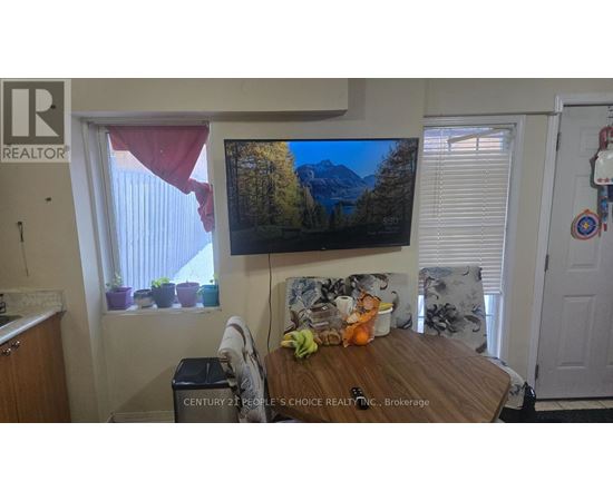 A living room with a flat screen TV mounted on the wall.