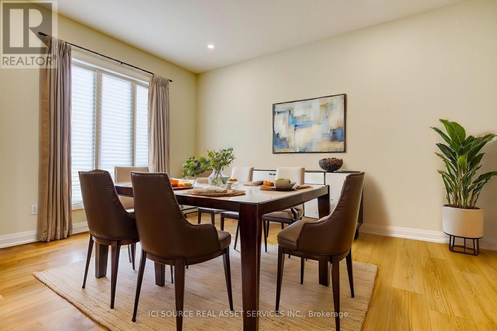 A dining room with a table set for four.