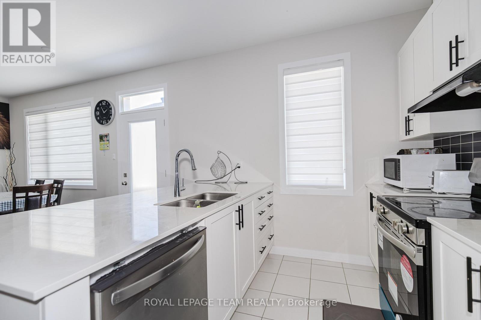 A white kitchen with a dishwasher and stove top oven.