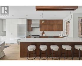 A modern kitchen with white cabinets and a wooden island.