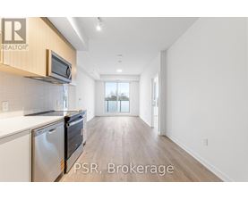 A kitchen with a microwave and oven above the counter.