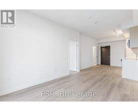 A spacious room with wooden flooring and white walls, labeled "PSR, Brokerage".