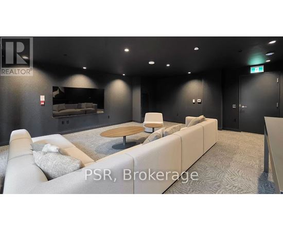A modern living room with a grey carpet and a white sofa.