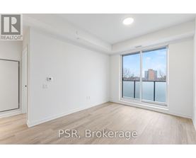 A room with a window showing a view of a building outside.
