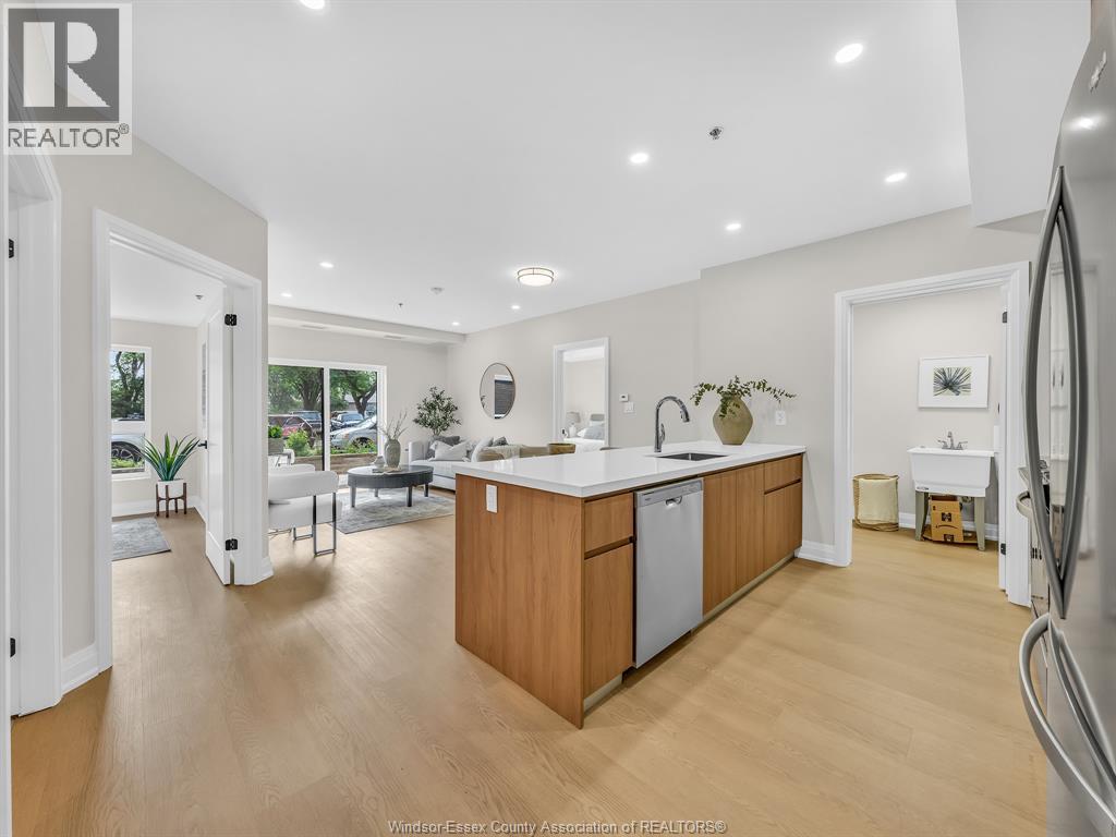 A kitchen with wooden cabinets and a refrigerator.