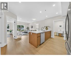 A kitchen with wooden cabinets and a refrigerator.