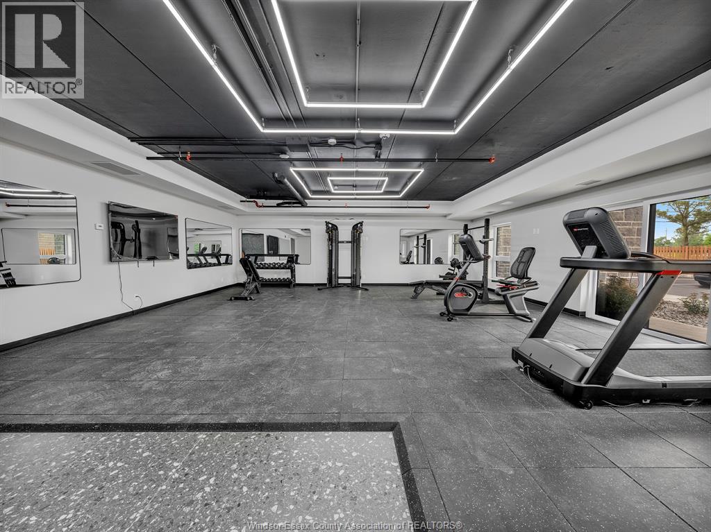 A gym with a variety of equipment including treadmills, weights, and exercise machines.