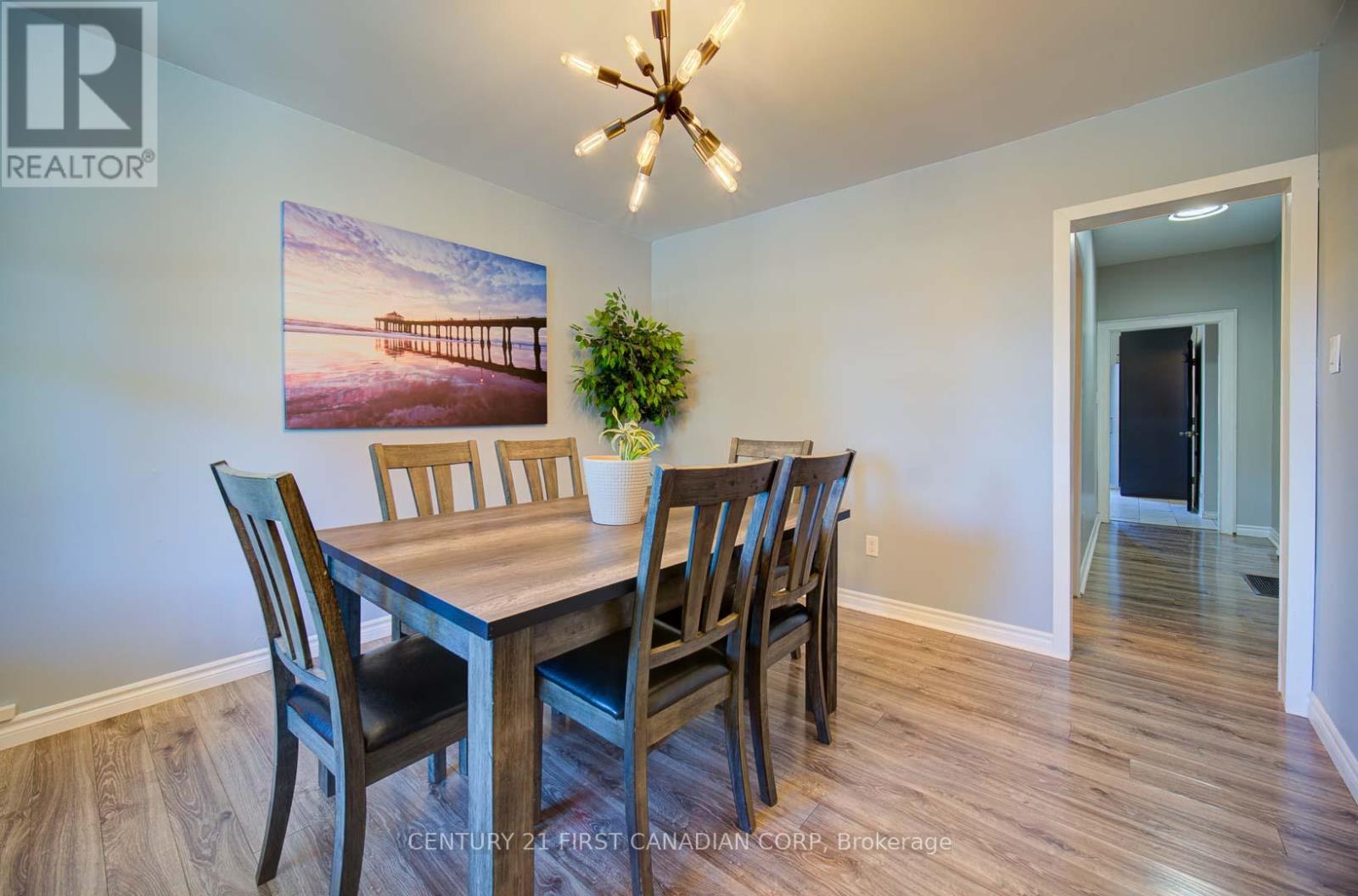 A dining room with a wooden table and chairs.