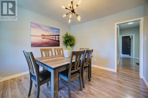 A dining room with a wooden table and chairs.