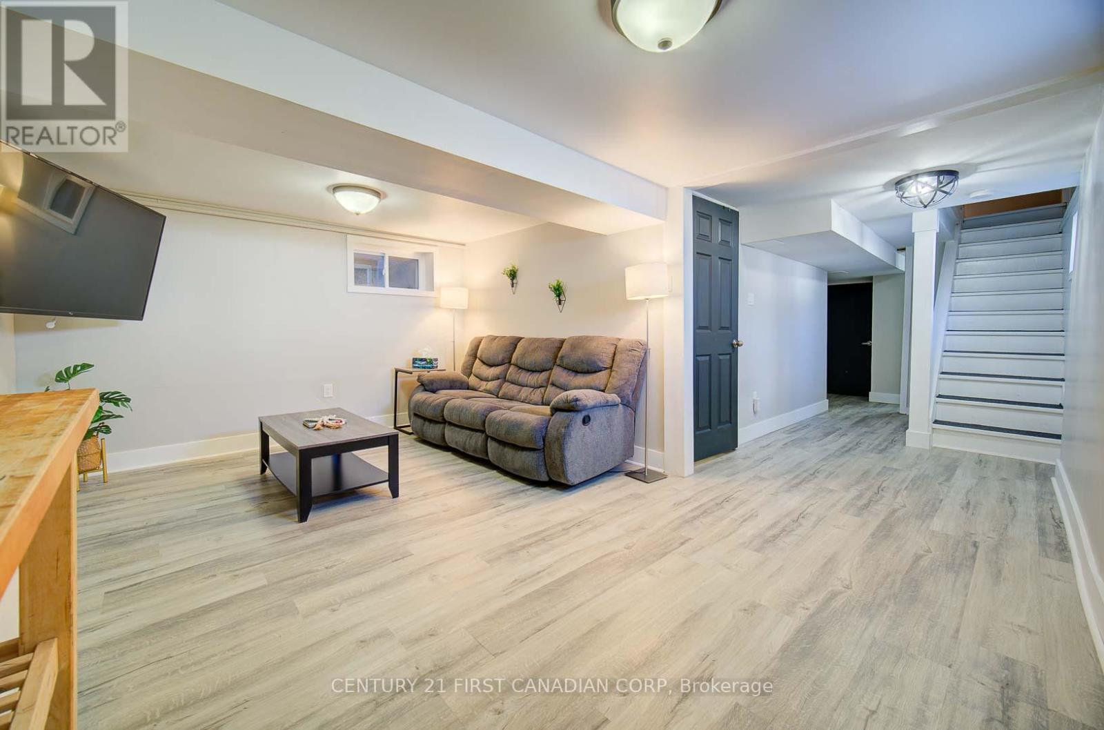A living room with a couch, a coffee table, and a television.