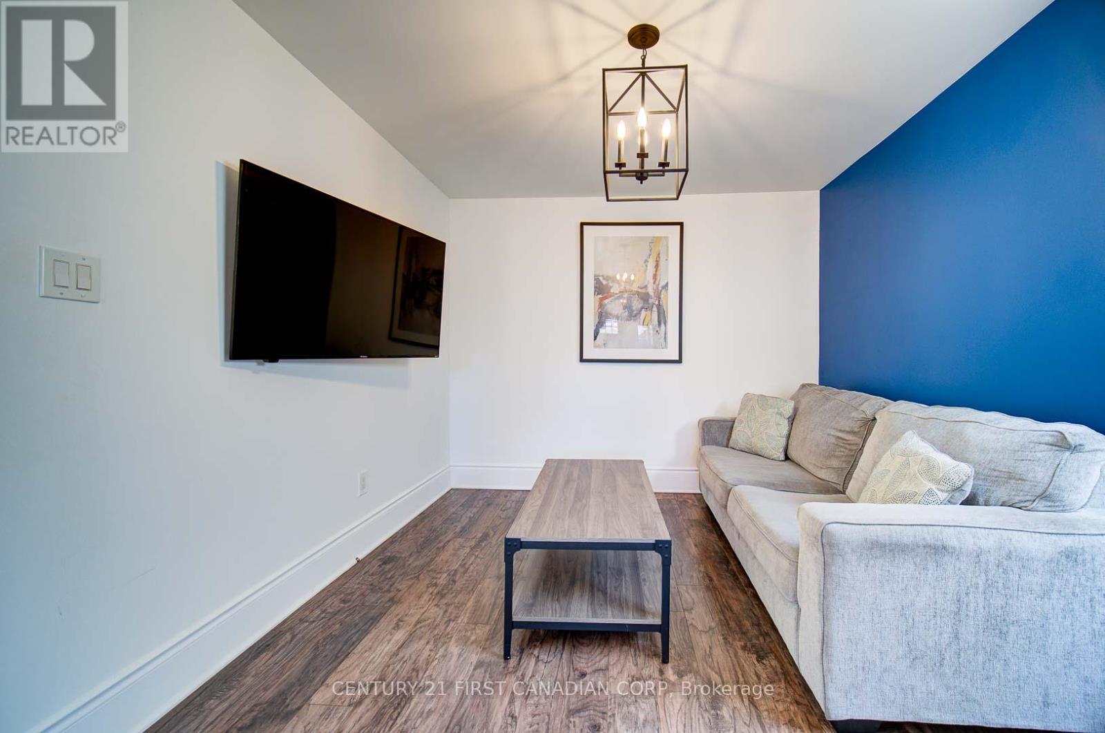 A living room with a white couch and a wooden coffee table.