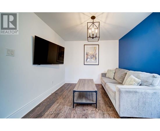 A living room with a white couch and a wooden coffee table.