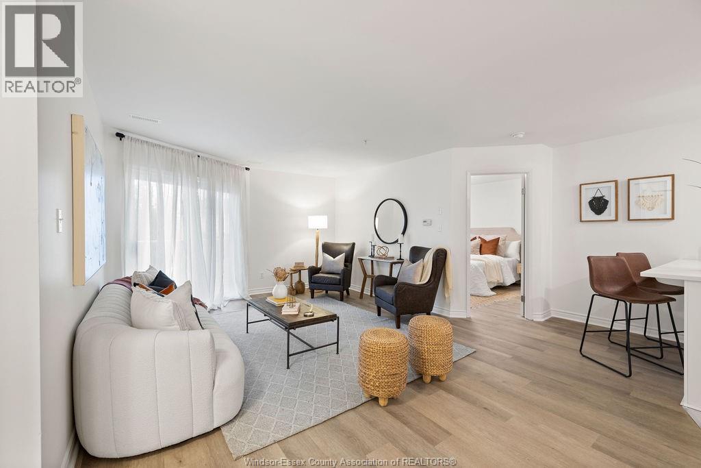 A living room with a white sofa and a wooden coffee table.