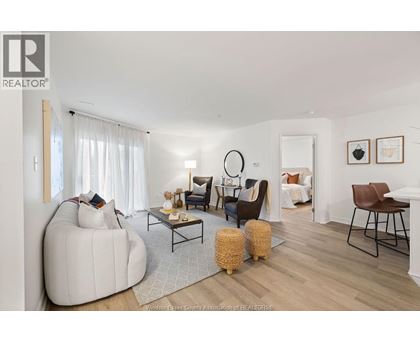 A living room with a white sofa and a wooden coffee table.