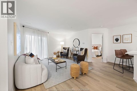 A living room with a white sofa and a wooden coffee table.