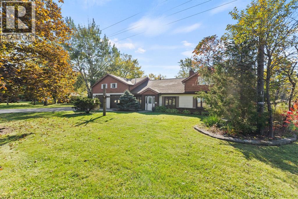 A house with a lawn and trees in the background.