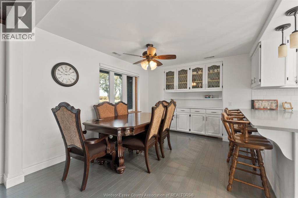 A dining room with a table and chairs.