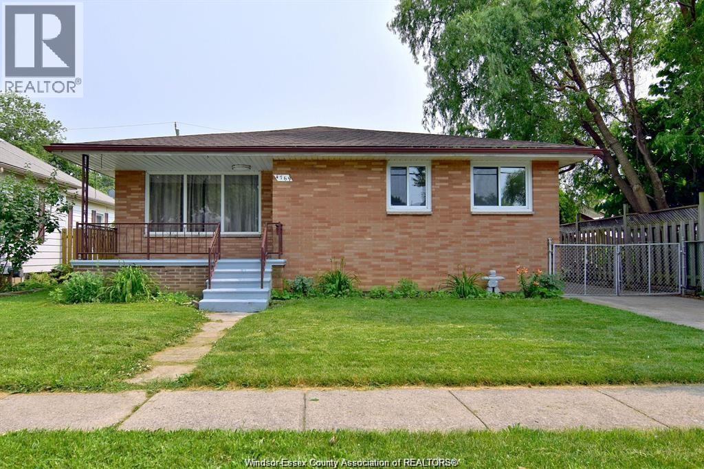 A house with a brown brick exterior and a white window.