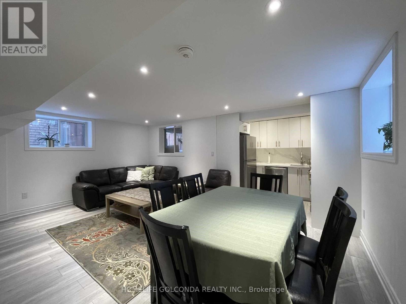 A well-lit dining room with a table set for six.
