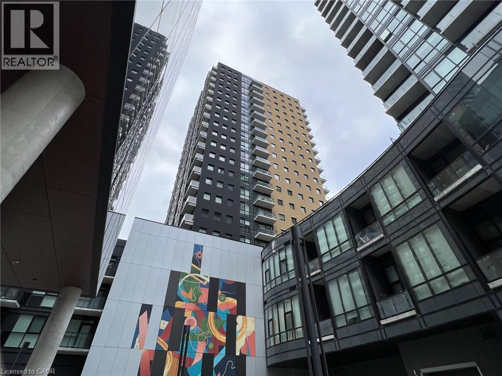 A tall building with a mural on the side of it.