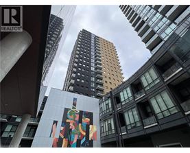 A tall building with a mural on the side of it.