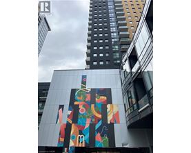 A tall building with a colorful mural on its side.