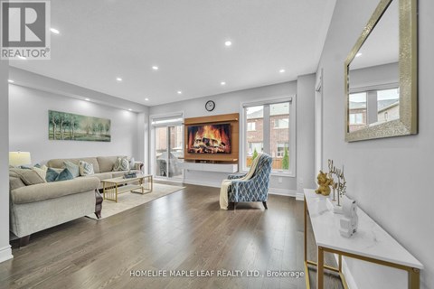 A living room with a fireplace and a painting on the wall.
