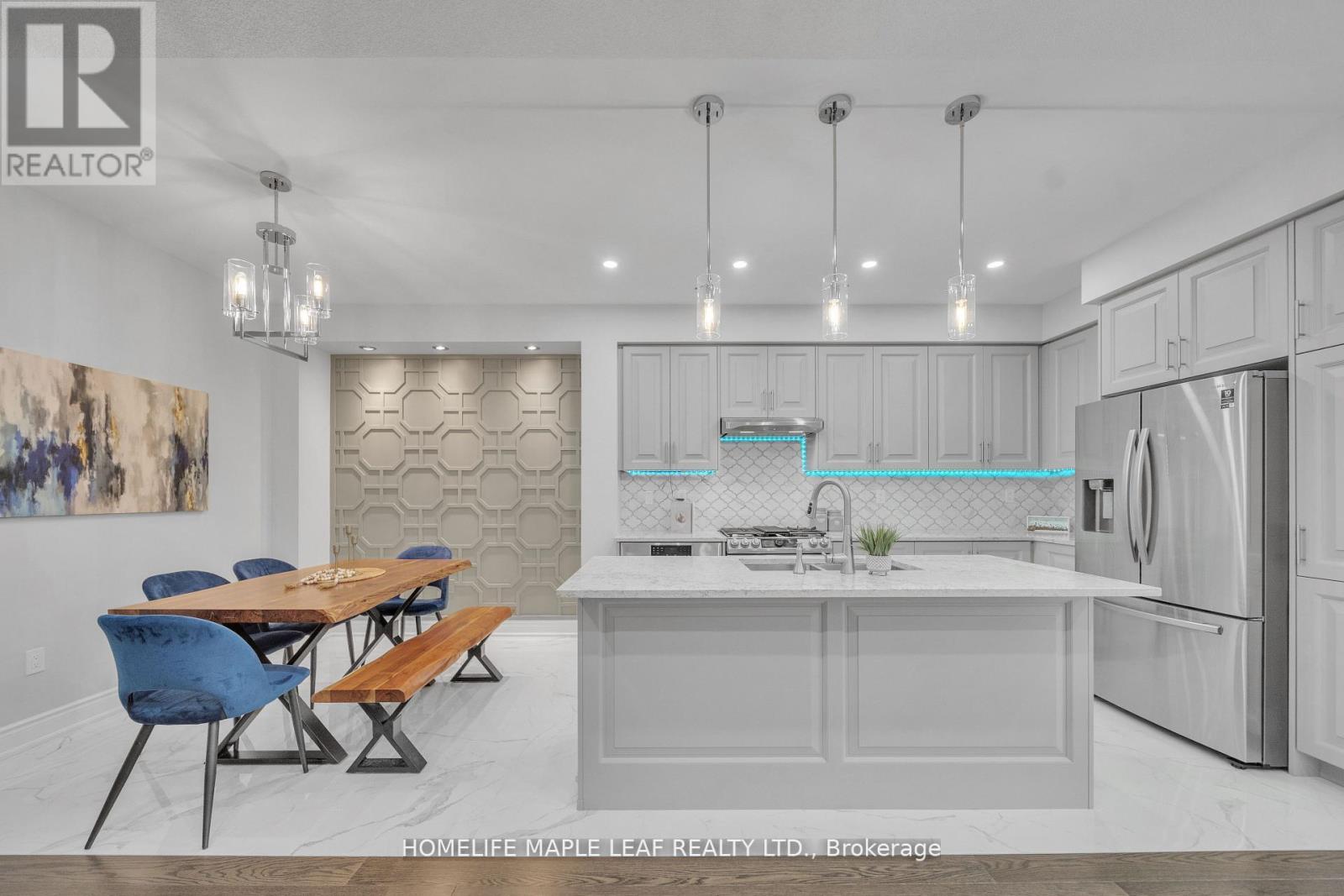 A modern kitchen with a dining table and chairs.