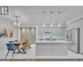A modern kitchen with a dining table and chairs.