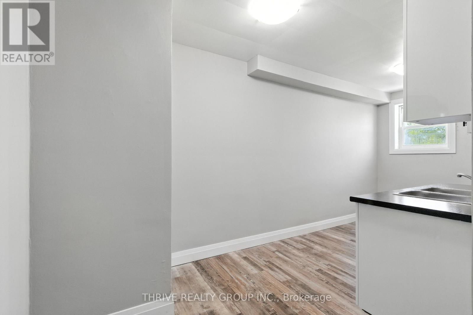 A white room with a window and a sink.