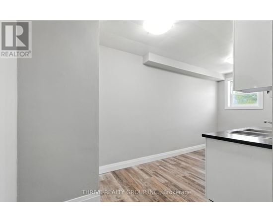 A white room with a window and a sink.