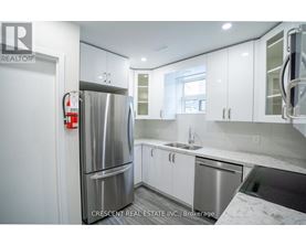 A kitchen with white cabinets and a black stove top oven.