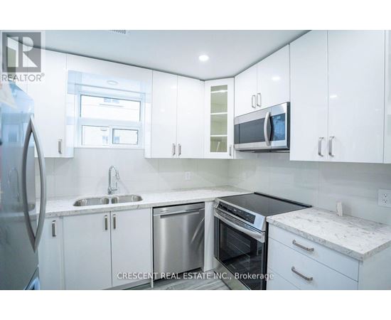 A kitchen with white cabinets and a black stove top oven.