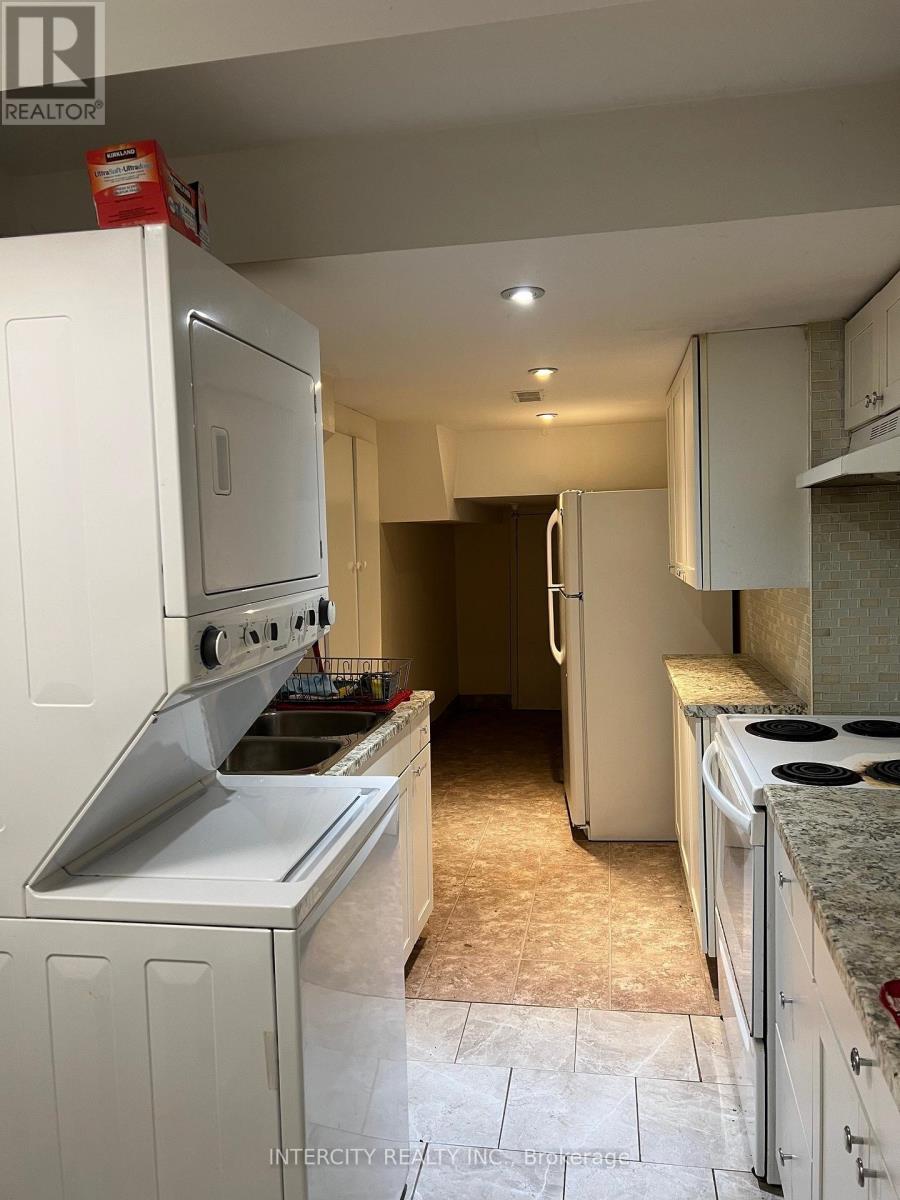 A kitchen with white appliances and cabinets.