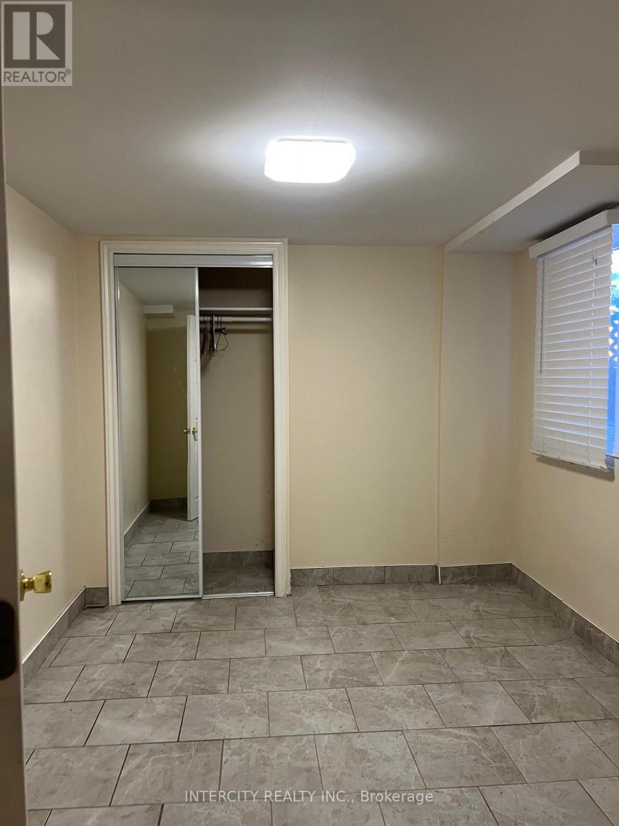A room with a tiled floor and a doorway leading to another room.