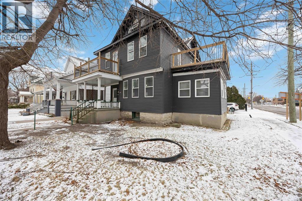 A house with a snow-covered ground in front.