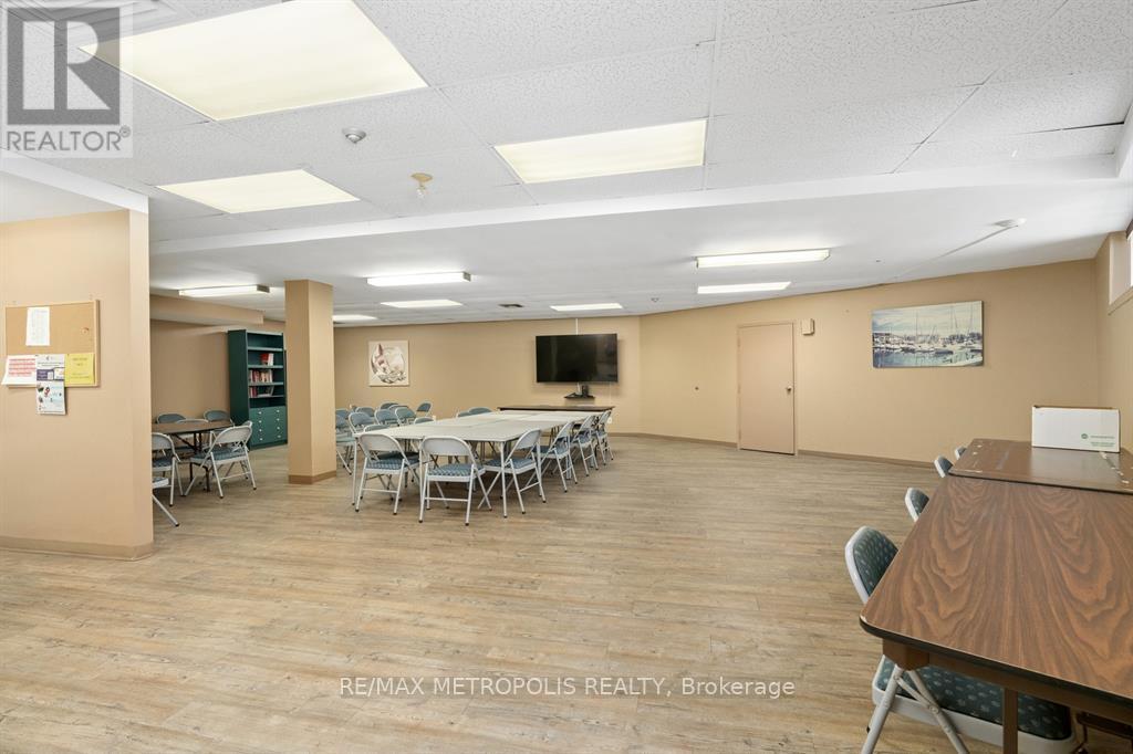 A conference room with a long table and chairs.