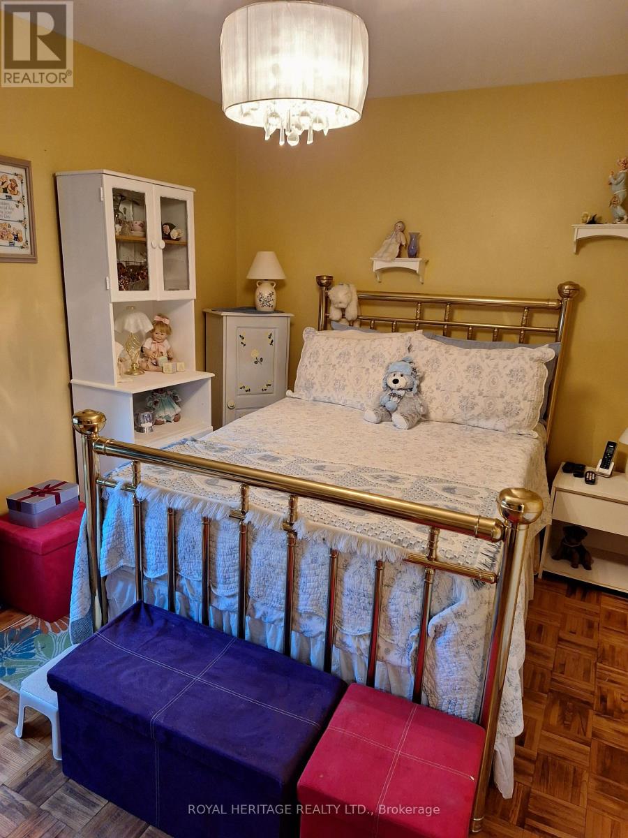 A bedroom with a bed, nightstand, and a chest of drawers.