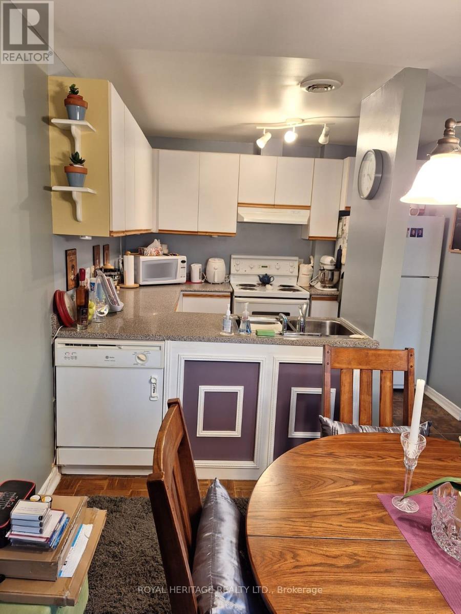 A kitchen with a table and chairs in the foreground.