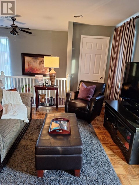 A living room with a brown leather chair and a brown coffee table.