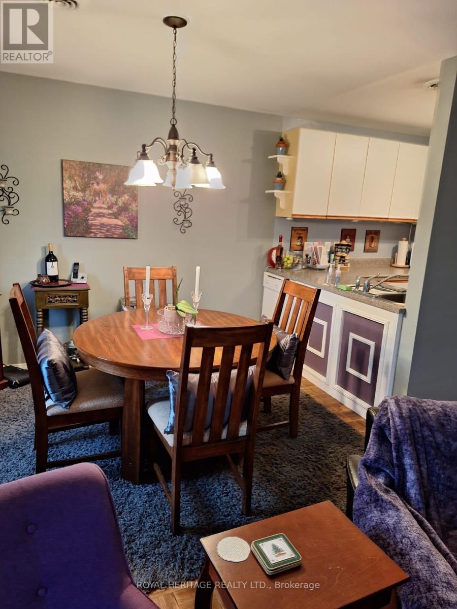 A dining room with a table set for four.