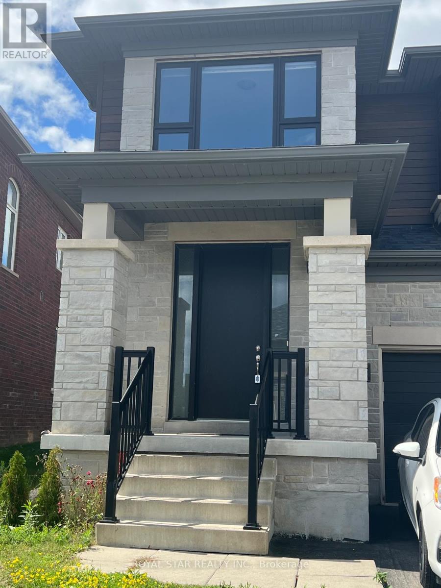 A house with a black door and a car parked in front.