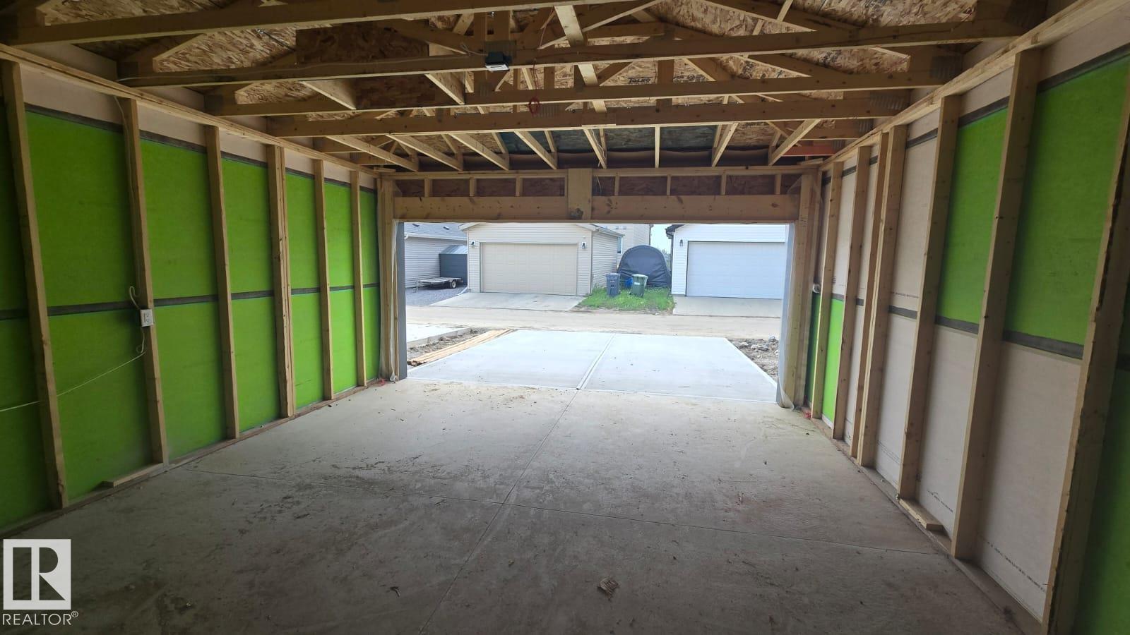 A construction site with a few buildings and a chair in the foreground.