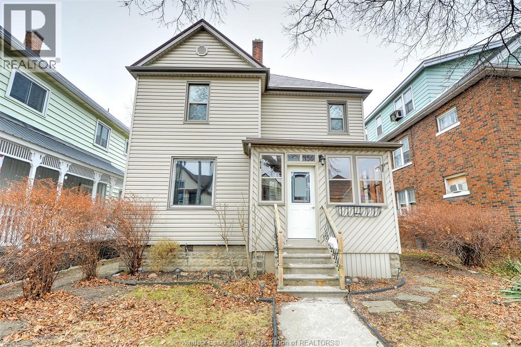 A house with a front yard and a small porch.