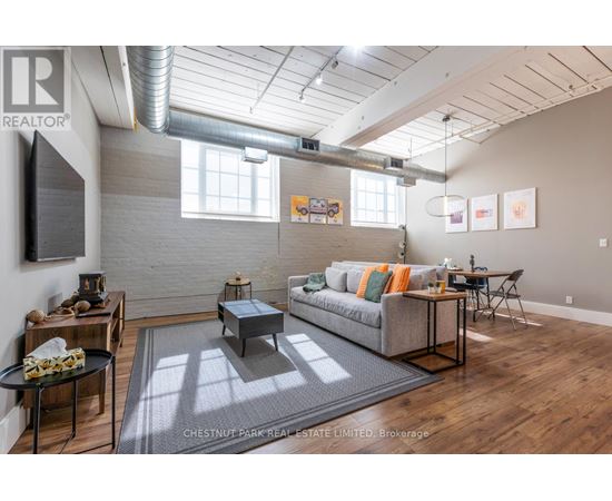 A living room with a grey couch and a coffee table.