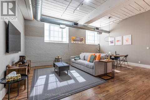 A living room with a grey couch and a coffee table.
