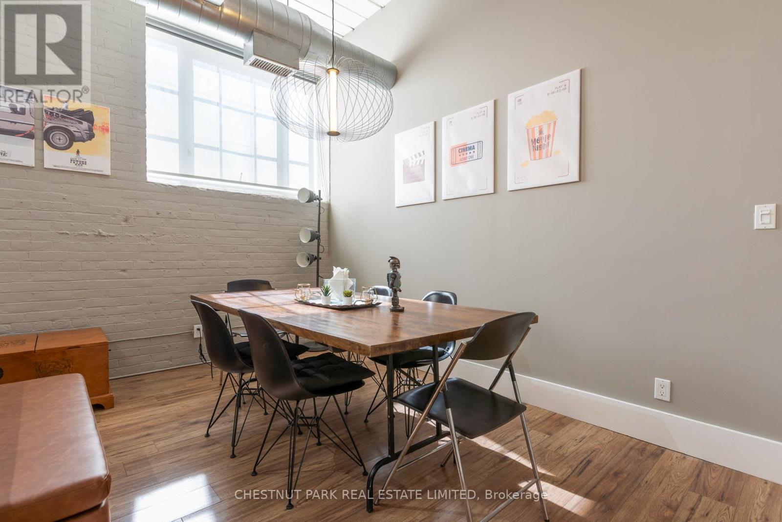 A dining room with a wooden table and chairs.