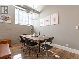 A dining room with a wooden table and chairs.