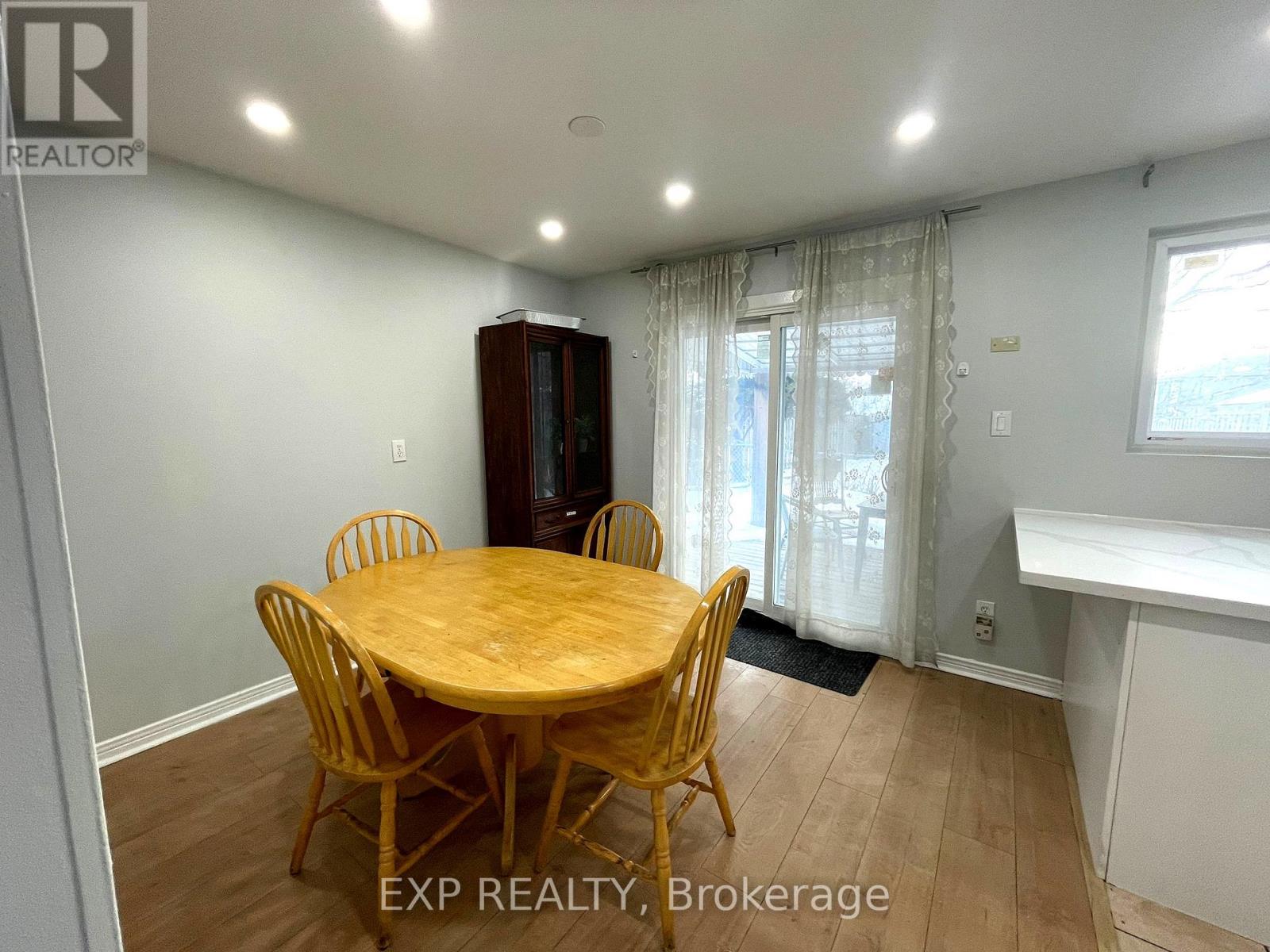 A dining room with a wooden table and chairs.